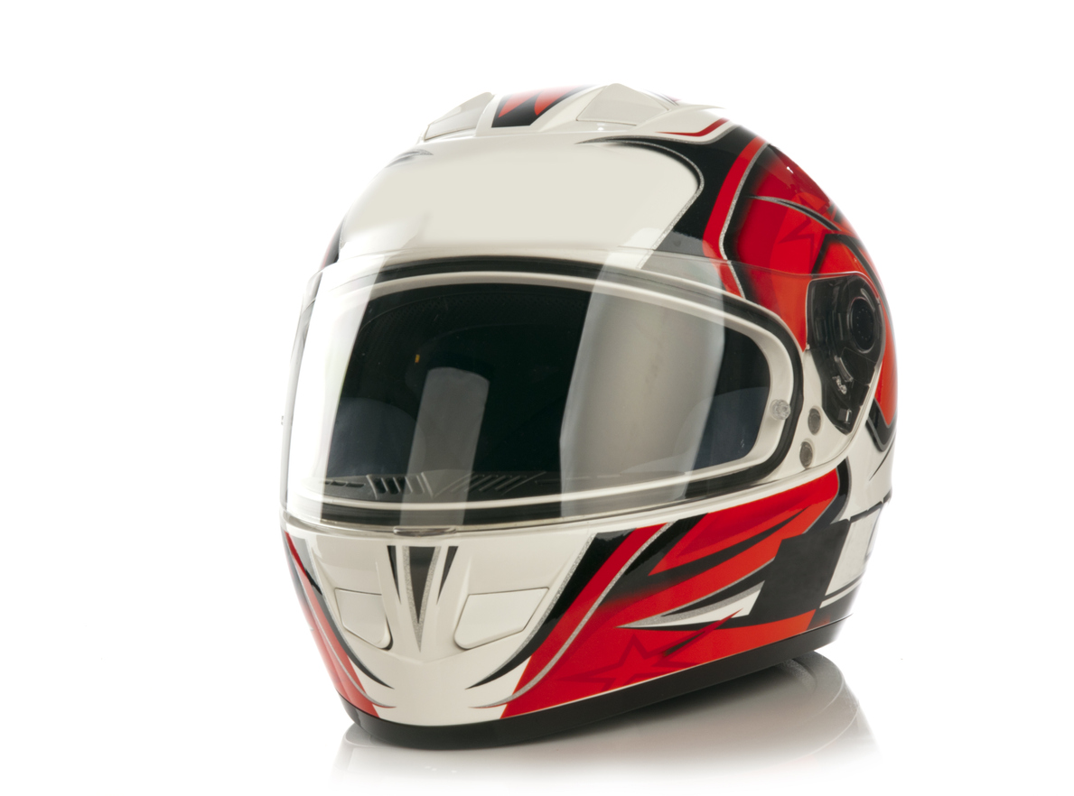 Colour motorcycle helmet isolated on white background with reflection